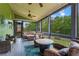 Inviting screened porch with comfortable seating, a ceiling fan, and serene views of the green backyard at 7493 Elderberry Dr, Douglasville, GA 30135