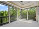 Spacious screened-in porch with carpeting and views of the surrounding trees at 7493 Elderberry Dr, Douglasville, GA 30135