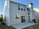 Backyard of home showing patio, sliding glass doors, and neutral colored siding at 8850 Grappe Trace, Suwanee, GA 30024