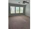 Bright bedroom with plush carpet, ceiling fan, and view of neighborhood at 8850 Grappe Trace, Suwanee, GA 30024