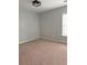Comfortable bedroom with plush carpet, ceiling fan, and a window at 8850 Grappe Trace, Suwanee, GA 30024