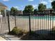 Community pool area with a secure black metal fence and lounge chairs surrounding the pool at 8850 Grappe Trace, Suwanee, GA 30024
