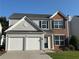 Charming two-story home featuring a two-car garage and brick accents at 8850 Grappe Trace, Suwanee, GA 30024