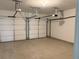 A two car garage space with overhead door openers and concrete flooring at 8850 Grappe Trace, Suwanee, GA 30024