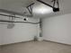 A vacant garage space with overhead door openers and concrete flooring at 8850 Grappe Trace, Suwanee, GA 30024