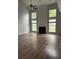 Bright and spacious living room with fireplace, tall windows, and hardwood floors at 8850 Grappe Trace, Suwanee, GA 30024