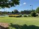 Well maintained community tennis courts with a manicured lawn and trees at 8850 Grappe Trace, Suwanee, GA 30024