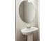 Bathroom with a pedestal sink and a large oval mirror at 2111 Wesson Ct, Kennesaw, GA 30144