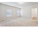 Spacious bedroom with two windows and neutral carpet and paint at 2111 Wesson Ct, Kennesaw, GA 30144