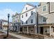 New three-story townhomes featuring a combination of lap siding and stone accents at 2111 Wesson Ct, Kennesaw, GA 30144