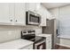 Close-up of the kitchen featuring stainless steel appliances and white countertops at 2111 Wesson Ct, Kennesaw, GA 30144