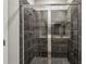 Tiled shower enclosure with glass doors and rainfall shower head at 2111 Wesson Ct, Kennesaw, GA 30144