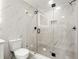 Modern bathroom featuring a glass shower, marble-style walls, and updated fixtures at 2828 Cloverhurst Dr, Atlanta, GA 30344