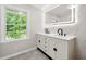 Bathroom featuring a double sink vanity with modern fixtures and a large illuminated mirror at 2828 Cloverhurst Dr, Atlanta, GA 30344