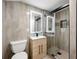 Modern tiled bathroom showcasing a glass shower and sleek vanity with an illuminated mirror at 2828 Cloverhurst Dr, Atlanta, GA 30344