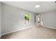 Comfortable bedroom with carpeting, a window, and a view towards the entry door at 2828 Cloverhurst Dr, Atlanta, GA 30344