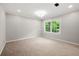 Spacious bedroom with new carpet, a large window, and recessed lighting at 2828 Cloverhurst Dr, Atlanta, GA 30344