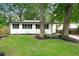 Charming one story home with black trim, a green lawn and mature trees at 2828 Cloverhurst Dr, Atlanta, GA 30344