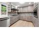 Bright kitchen featuring stainless steel appliances, wood-look cabinets, and granite countertops at 2828 Cloverhurst Dr, Atlanta, GA 30344