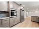Kitchen with stainless steel appliances and wood-look cabinets with a connecting room at 2828 Cloverhurst Dr, Atlanta, GA 30344