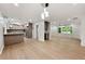 Spacious living room featuring new laminate floors, light fixtures and kitchen view at 2828 Cloverhurst Dr, Atlanta, GA 30344