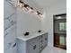 Bathroom featuring quartz countertop, gray vanity, and black lighting fixtures at 3599 Centerville Rosebud Rd, Snellville, GA 30039