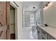 Bright bathroom featuring white marble floors, modern fixtures, and separate tub at 3599 Centerville Rosebud Rd, Snellville, GA 30039