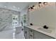 Modern bathroom featuring marble walls, soaking tub, dual sink vanity, and natural light at 3599 Centerville Rosebud Rd, Snellville, GA 30039