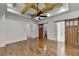 Bedroom boasts wood floors, a decorative wall, modern ceiling fan, and sliding barn doors at 3599 Centerville Rosebud Rd, Snellville, GA 30039