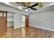 Bedroom boasts wood floors, a decorative wall, modern ceiling fan, and sliding barn doors at 3599 Centerville Rosebud Rd, Snellville, GA 30039
