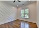 Spacious bedroom features statement wall, hardwood floors, and large window at 3599 Centerville Rosebud Rd, Snellville, GA 30039