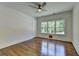 Neutral bedroom with hardwood floors, large windows, and ceiling fan at 3599 Centerville Rosebud Rd, Snellville, GA 30039