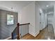 Hallway with wood floors, decorative gray wall, and staircase at 3599 Centerville Rosebud Rd, Snellville, GA 30039
