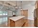 Charming kitchen island overlooks the living room with coffered ceilings and fireplace at 3599 Centerville Rosebud Rd, Snellville, GA 30039