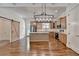 Bright kitchen with island, wood cabinets, stainless appliances, and sliding barn door at 3599 Centerville Rosebud Rd, Snellville, GA 30039