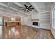 Open-concept living room with coffered ceilings, fireplace, custom built-ins, and hardwood floors at 3599 Centerville Rosebud Rd, Snellville, GA 30039