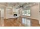 Comfortable living room with a fireplace, built-in shelving, and hardwood floors, bathed in natural light at 3599 Centerville Rosebud Rd, Snellville, GA 30039