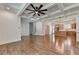 Open-concept living room with coffered ceilings, fireplace, custom built-ins, and hardwood floors at 3599 Centerville Rosebud Rd, Snellville, GA 30039