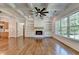 Open-concept living room with coffered ceilings, fireplace, custom built-ins, and hardwood floors at 3599 Centerville Rosebud Rd, Snellville, GA 30039