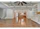 Open-concept living room with coffered ceilings, fireplace, custom built-ins, and hardwood floors at 3599 Centerville Rosebud Rd, Snellville, GA 30039