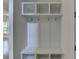 Mudroom features three hooks, overhead storage, and a bench with storage underneath at 3599 Centerville Rosebud Rd, Snellville, GA 30039