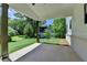 An open patio with white ceilings and exposed support beams overlooks a lush green lawn at 3599 Centerville Rosebud Rd, Snellville, GA 30039