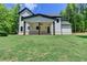 An expansive green lawn with a covered patio and white siding defines the rear exterior at 3599 Centerville Rosebud Rd, Snellville, GA 30039