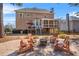 Inviting backyard patio with fire pit, wood chairs, and comfortable striped cushions perfect for entertaining guests at 3640 Ridgeway Ter, Suwanee, GA 30024