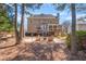 Charming backyard featuring a stone patio, inviting fire pit, and screened in porch for outdoor relaxation at 3640 Ridgeway Ter, Suwanee, GA 30024