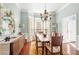 Dining room with hardwood floors, a bay window, and a decorative chandelier at 3640 Ridgeway Ter, Suwanee, GA 30024