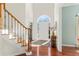 Inviting foyer featuring hardwood floors, staircase with iron railings, and ample natural light at 3640 Ridgeway Ter, Suwanee, GA 30024