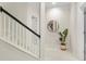 Bright hallway features a staircase, a decorative mirror, and a potted plant at 3640 Ridgeway Ter, Suwanee, GA 30024