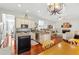 Open-concept kitchen adjacent to the living area, complete with stainless steel appliances and center island at 3640 Ridgeway Ter, Suwanee, GA 30024