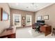 Dedicated home office featuring dual monitors and ample natural light from two windows at 3640 Ridgeway Ter, Suwanee, GA 30024